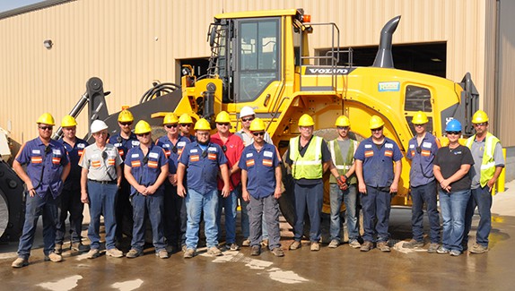 group of site workers in front of machine